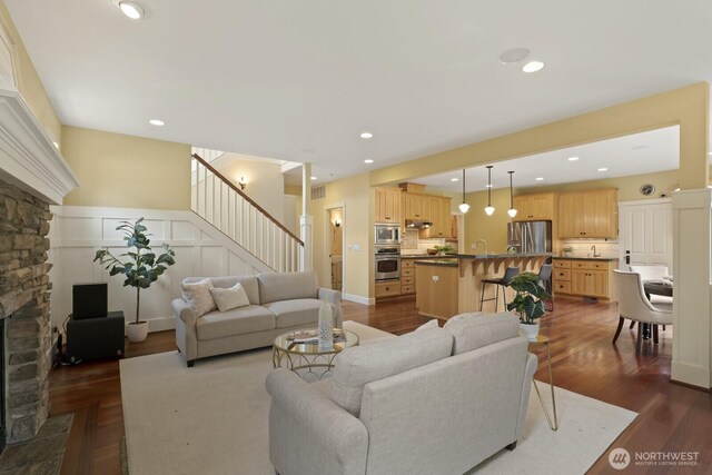 27 148th Pl SW, Lynnwood, WA 98087 - living area with stairs, dark wood-style floors, recessed lighting, and a stone fireplace