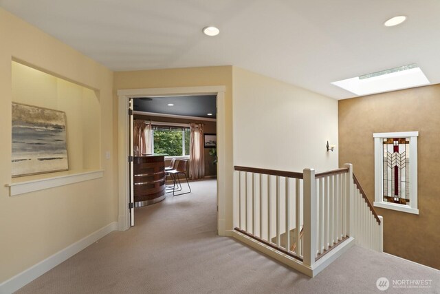 27 148th Pl SW, Lynnwood, WA 98087 - hall with an upstairs landing, a skylight, carpet floors, recessed lighting, and baseboards