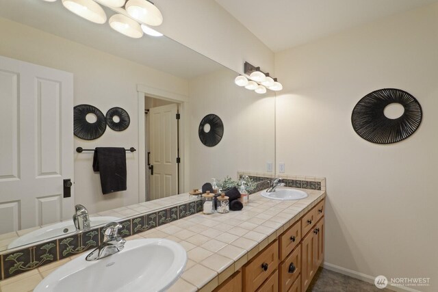 27 148th Pl SW, Lynnwood, WA 98087 - bathroom featuring double vanity and baseboards