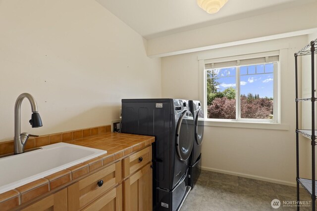 27 148th Pl SW, Lynnwood, WA 98087 - laundry area featuring washer and clothes dryer, cabinet space, and baseboards