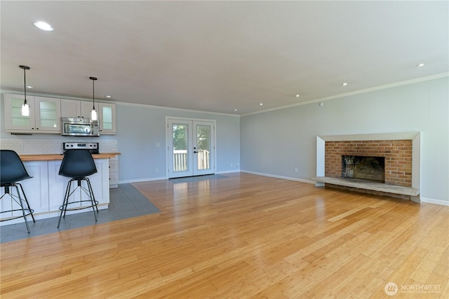 7519 221st Pl SW, Edmonds, WA 98026 - unfurnished living room with light wood-style floors, recessed lighting, ornamental molding, and a fireplace