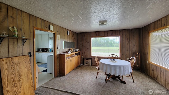 1296 US Highway 12, Chehalis, WA 98532 - dining area with washer and dryer, wood walls, and light colored carpet