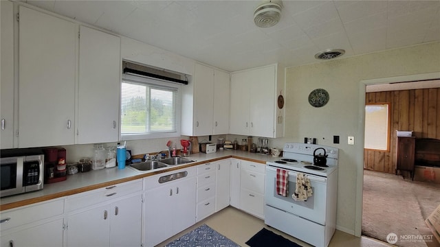 1296 US Highway 12, Chehalis, WA 98532 - kitchen featuring white electric range, a sink, stainless steel microwave, light countertops, and white cabinets