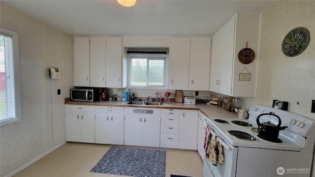 1296 US Highway 12, Chehalis, WA 98532 - kitchen featuring white electric stove, stainless steel microwave, a sink, white cabinets, and light countertops