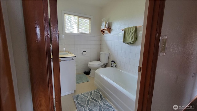 1296 US Highway 12, Chehalis, WA 98532 - bathroom with vanity, toilet, a bath, and a wainscoted wall