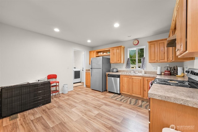 8450 Hazel Ct, Maple Falls, WA 98266 - kitchen with appliances with stainless steel finishes, washer / dryer, under cabinet range hood, light wood-type flooring, and light countertops
