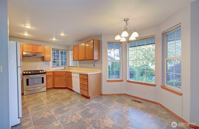 10010 NE 76th Cir, Vancouver, WA 98662 - kitchen featuring white appliances, a chandelier, light countertops, recessed lighting, and decorative light fixtures