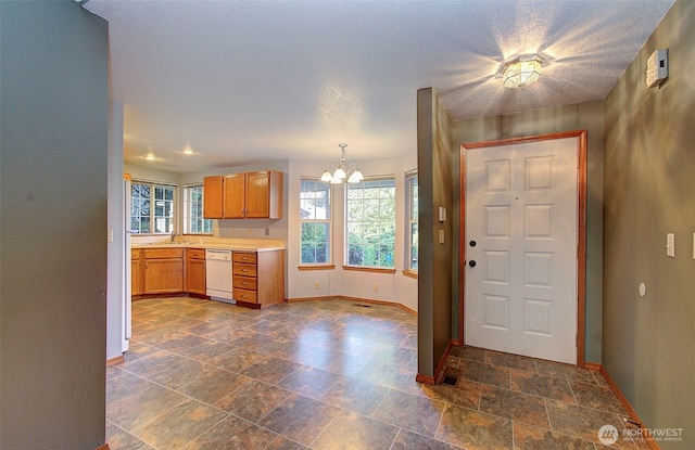10010 NE 76th Cir, Vancouver, WA 98662 - kitchen with a chandelier, dark stone finish floors, light countertops, white appliances, and decorative light fixtures