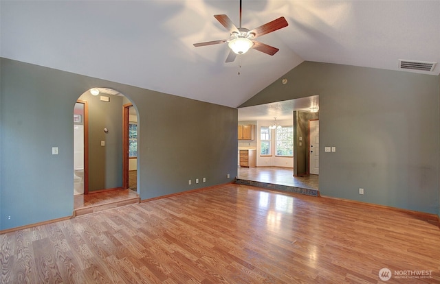 10010 NE 76th Cir, Vancouver, WA 98662 - empty room with ceiling fan, arched walkways, wood finished floors, and high vaulted ceiling