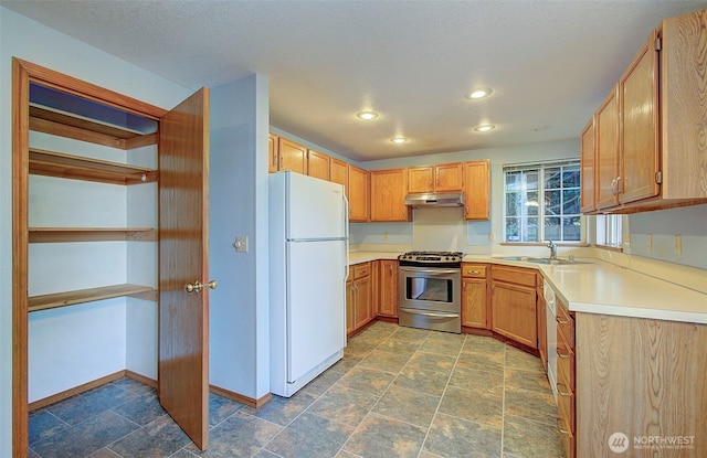10010 NE 76th Cir, Vancouver, WA 98662 - kitchen featuring freestanding refrigerator, stainless steel range with gas stovetop, light countertops, recessed lighting, and stone finish flooring