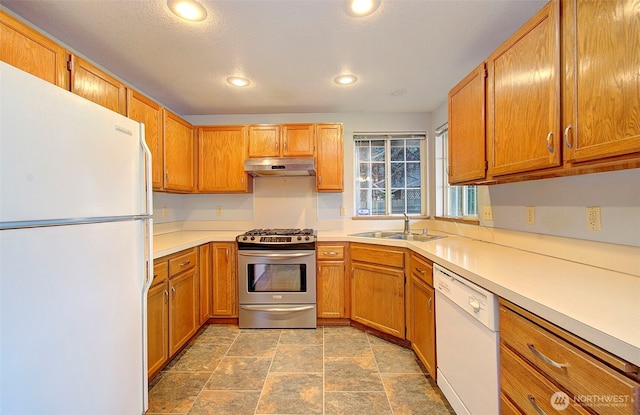 10010 NE 76th Cir, Vancouver, WA 98662 - kitchen with white appliances, light countertops, recessed lighting, under cabinet range hood, and stone finish flooring