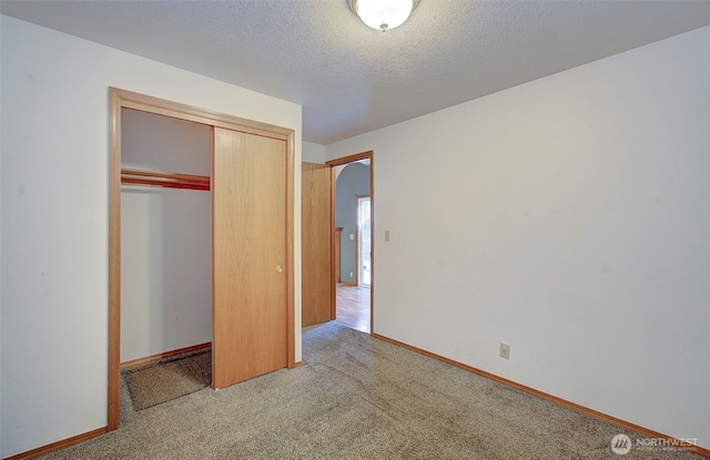 10010 NE 76th Cir, Vancouver, WA 98662 - unfurnished bedroom featuring light colored carpet, a closet, and a textured ceiling