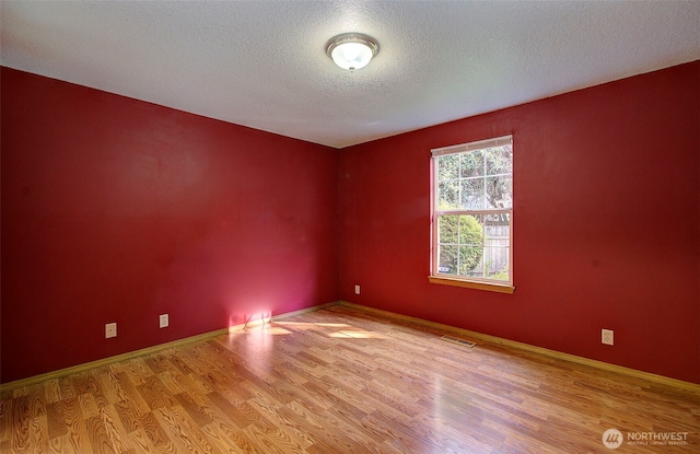 10010 NE 76th Cir, Vancouver, WA 98662 - empty room featuring wood finished floors and a textured ceiling