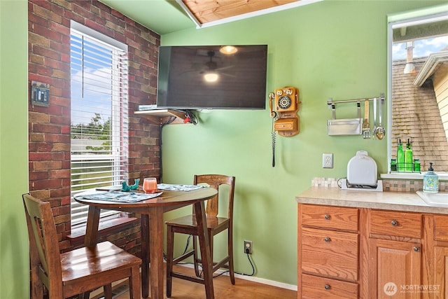 7005 Helweg Ln, Blaine, WA 98230 - dining room with brick wall, wood finished floors, and baseboards