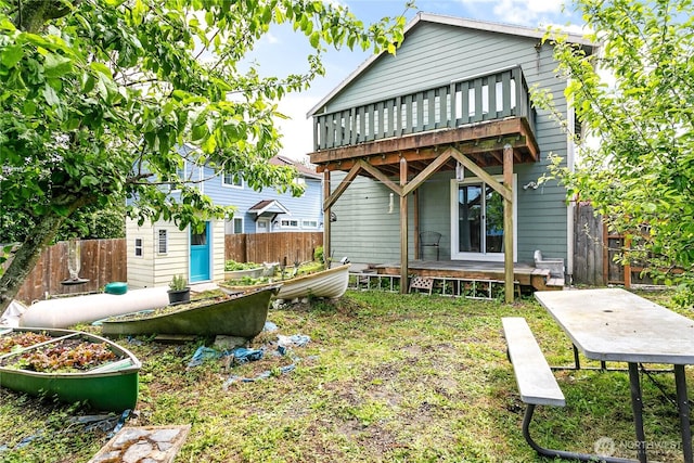 7005 Helweg Ln, Blaine, WA 98230 - rear view of house featuring a vegetable garden, a fenced backyard, and a deck