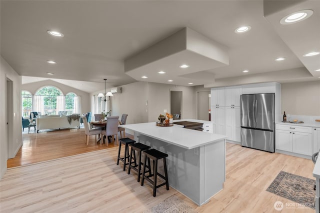 4680 State Route 6, Chehalis, WA 98532 - kitchen with freestanding refrigerator, light wood-type flooring, white cabinets, light countertops, and a large island
