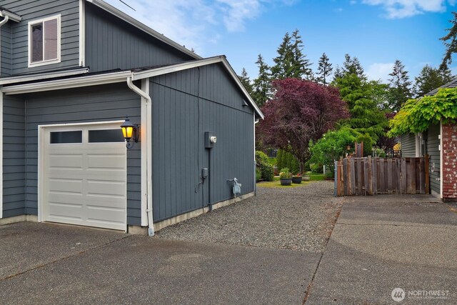 4421 166th Ave E, Lake Tapps, WA 98391 - view of side of home featuring a garage and asphalt driveway