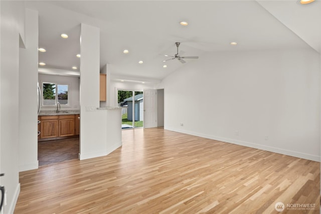 26908 NE Stewart St, Duvall, WA 98019 - unfurnished living room with a ceiling fan, light wood finished floors, recessed lighting, lofted ceiling, and baseboards