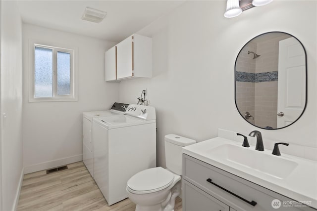 26908 NE Stewart St, Duvall, WA 98019 - full bath with independent washer and dryer, toilet, vanity, wood finished floors, and a shower
