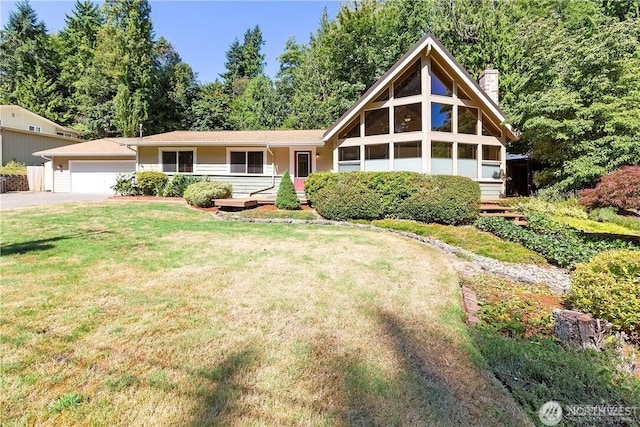 1360 Colchester Dr SE, Port Orchard, WA 98366 - view of front facade with a garage, driveway, a front lawn, and a chimney