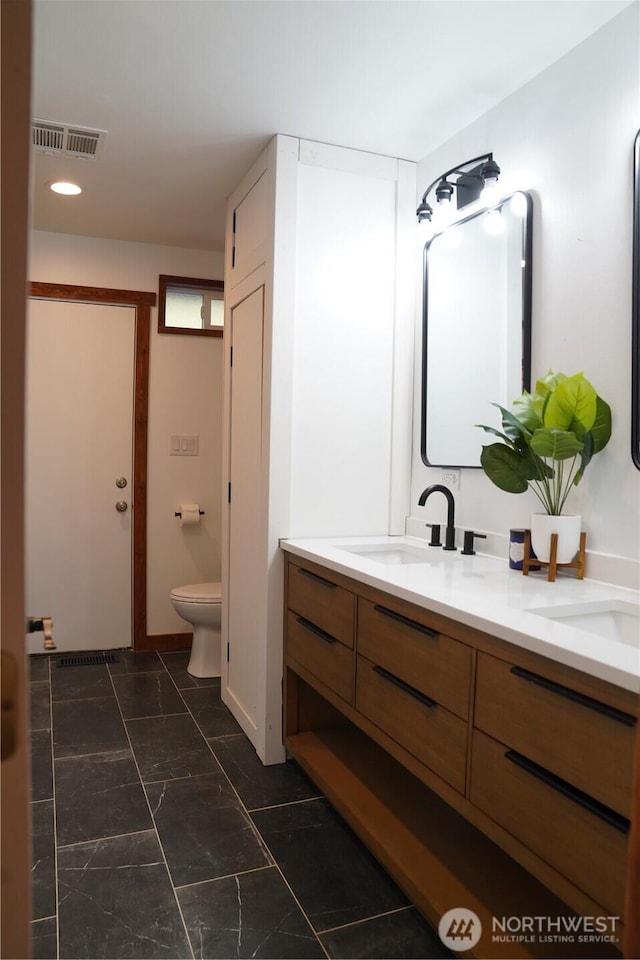 1360 Colchester Dr SE, Port Orchard, WA 98366 - full bath with double vanity, toilet, marble look tile flooring, and recessed lighting