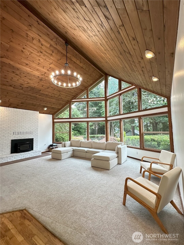 1360 Colchester Dr SE, Port Orchard, WA 98366 - carpeted living area with high vaulted ceiling, wooden ceiling, a chandelier, a brick fireplace, and recessed lighting