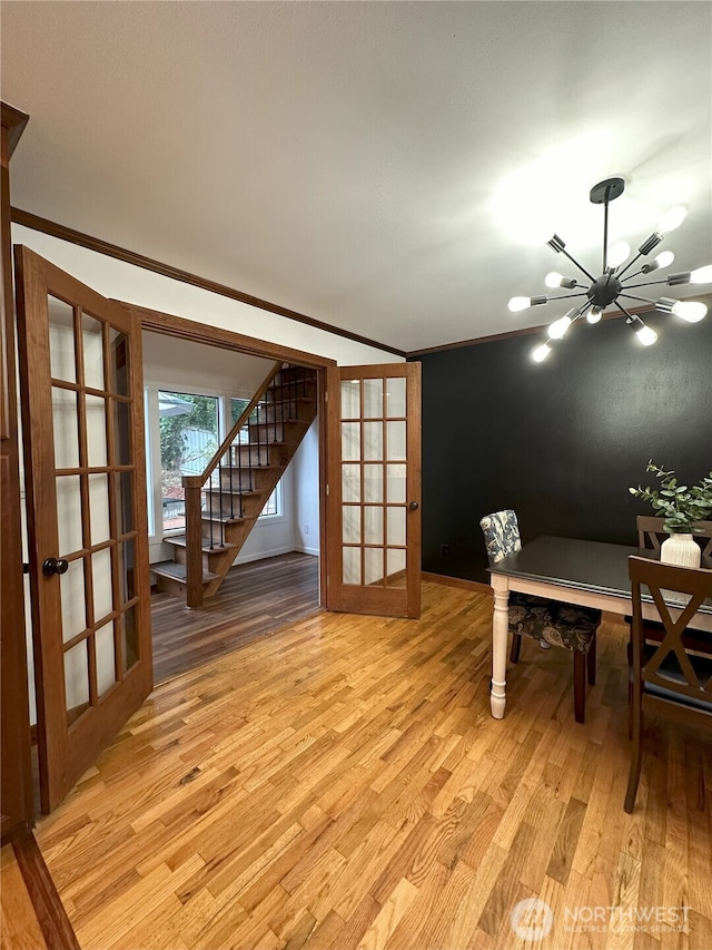 1360 Colchester Dr SE, Port Orchard, WA 98366 - dining area with stairs, light wood-style flooring, crown molding, a chandelier, and french doors