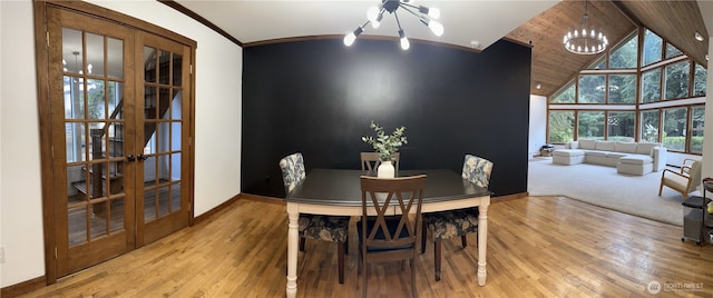 1360 Colchester Dr SE, Port Orchard, WA 98366 - dining area featuring french doors, a chandelier, wood finished floors, crown molding, and high vaulted ceiling