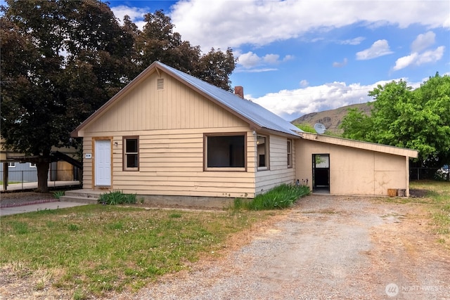318 Lombard St, Twisp, WA 98856 - ranch-style home featuring dirt driveway, a chimney, and metal roof