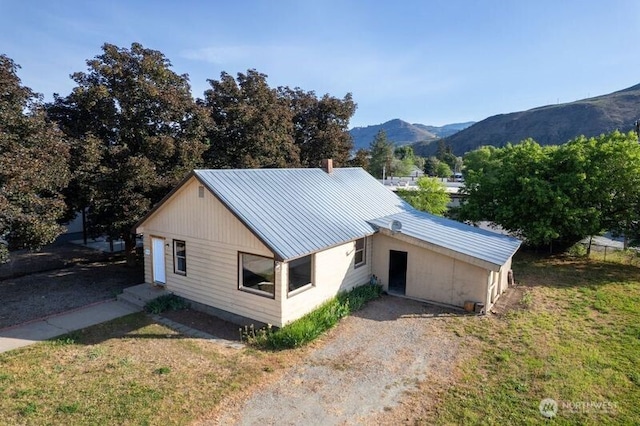 318 Lombard St, Twisp, WA 98856 - view of home's exterior with a mountain view, metal roof, and a yard