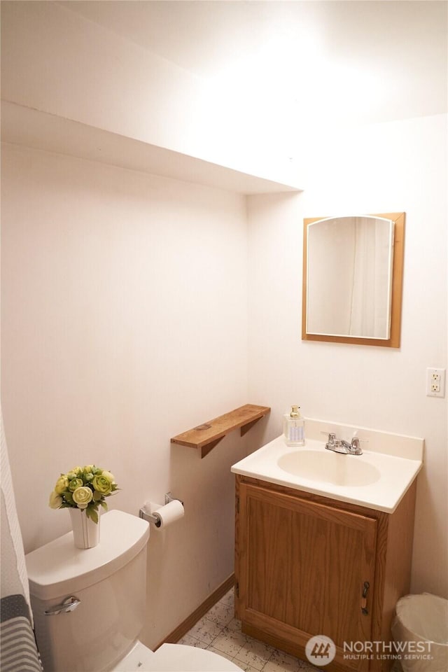 11433 12th Ave SW, Burien, WA 98146 - bathroom with toilet, vanity, and baseboards