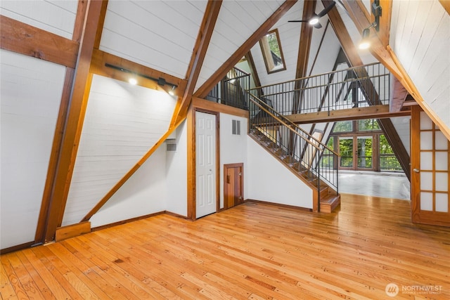 5617 236th Ave NE, Redmond, WA 98053 - unfurnished living room with wood-type flooring, baseboards, wooden ceiling with exposed beams, ceiling fan, and high vaulted ceiling