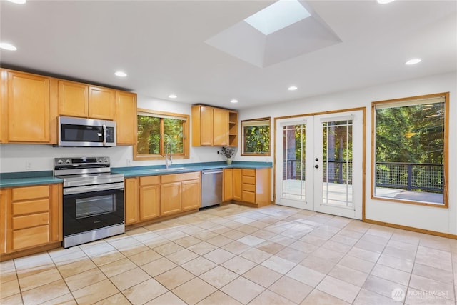 5617 236th Ave NE, Redmond, WA 98053 - kitchen featuring appliances with stainless steel finishes, plenty of natural light, french doors, a sink, and recessed lighting