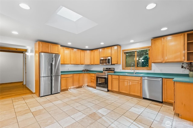 5617 236th Ave NE, Redmond, WA 98053 - kitchen featuring appliances with stainless steel finishes, a sink, recessed lighting, a skylight, and light tile patterned floors