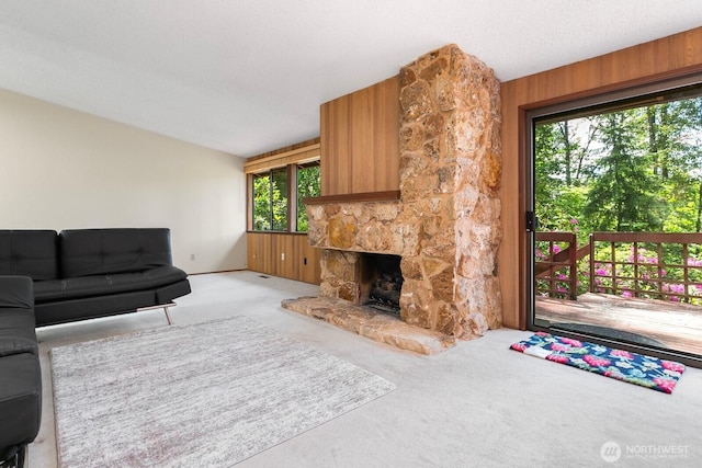 13219 SE 52nd Pl, Bellevue, WA 98006 - unfurnished living room with plenty of natural light, carpet flooring, a stone fireplace, and wooden walls