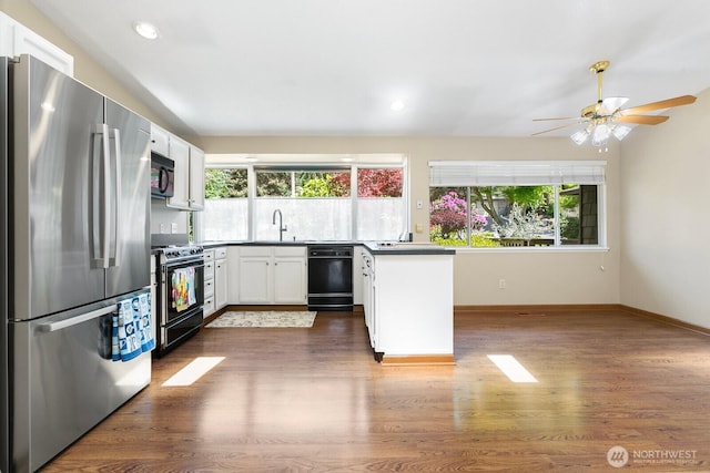 13219 SE 52nd Pl, Bellevue, WA 98006 - kitchen featuring black appliances, plenty of natural light, dark wood finished floors, white cabinets, and recessed lighting