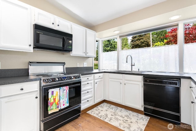 13219 SE 52nd Pl, Bellevue, WA 98006 - kitchen featuring black appliances, a sink, dark countertops, white cabinets, and wood finished floors