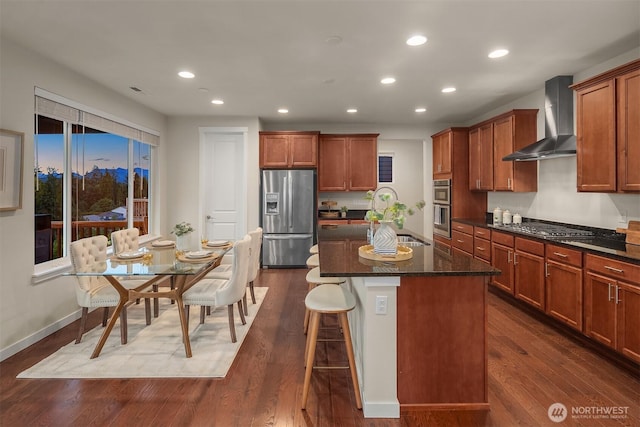28616 NE 155th St, Duvall, WA 98019 - kitchen featuring appliances with stainless steel finishes, wall chimney exhaust hood, recessed lighting, a kitchen island with sink, and a breakfast bar area