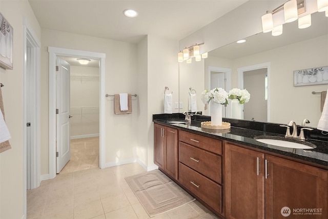 28616 NE 155th St, Duvall, WA 98019 - bathroom with double vanity, tile patterned floors, a walk in closet, baseboards, and recessed lighting