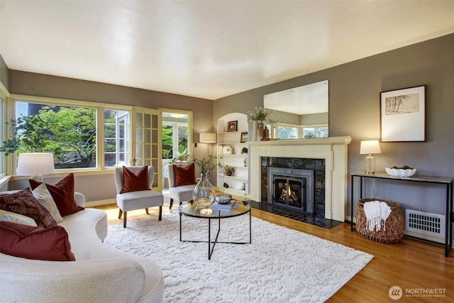 1635 46th Ave SW, Seattle, WA 98116 - living room with wood finished floors, a premium fireplace, and baseboards