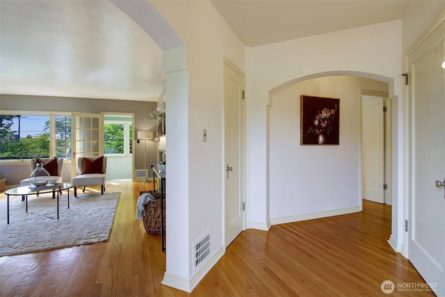 1635 46th Ave SW, Seattle, WA 98116 - hall with arched walkways, wood finished floors, and baseboards