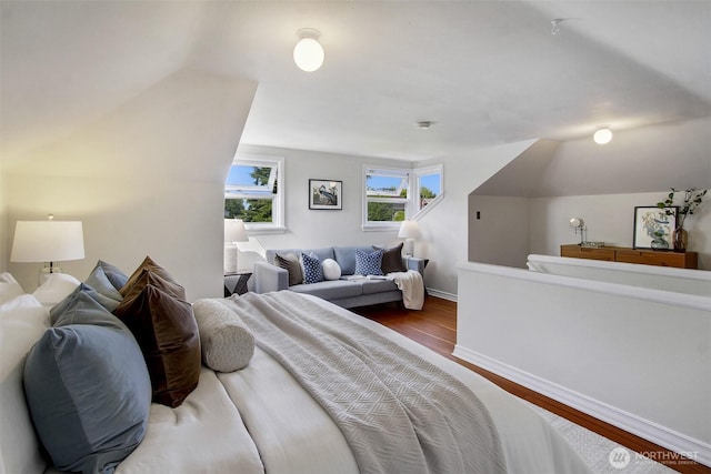 1635 46th Ave SW, Seattle, WA 98116 - bedroom featuring wood finished floors, baseboards, and vaulted ceiling