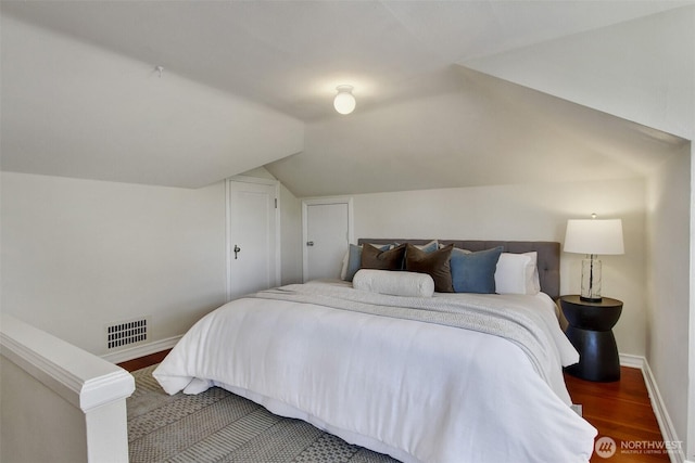 1635 46th Ave SW, Seattle, WA 98116 - bedroom featuring baseboards, wood finished floors, and vaulted ceiling