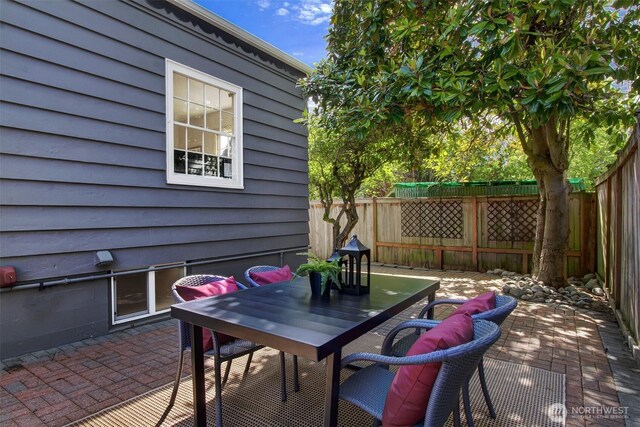 1635 46th Ave SW, Seattle, WA 98116 - fenced backyard featuring outdoor dining area and a patio