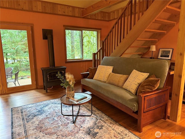7480 Glacier Springs Dr, Deming, WA 98244 - living room with wood finished floors, a wood stove, and stairway