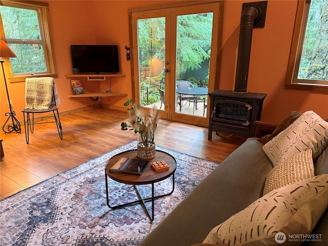 7480 Glacier Springs Dr, Deming, WA 98244 - living room featuring wood finished floors, a wood stove, and baseboards