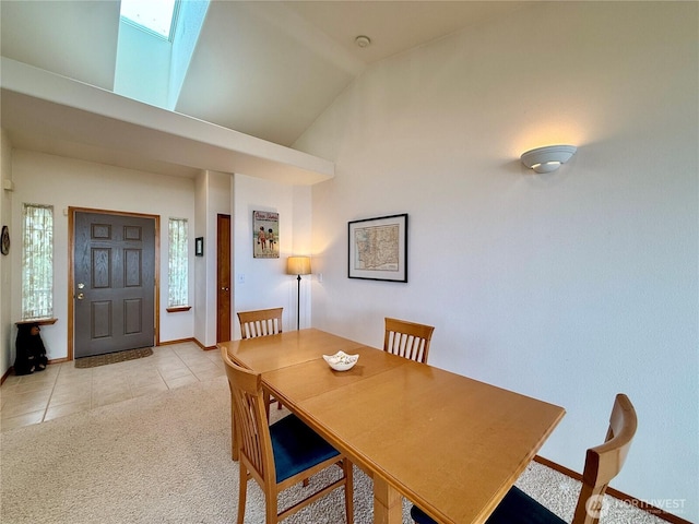 374 Harbor View Loop SE, Ocean Shores, WA 98569 - dining room featuring light tile patterned flooring, vaulted ceiling, light colored carpet, and baseboards