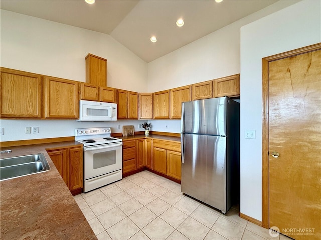 374 Harbor View Loop SE, Ocean Shores, WA 98569 - kitchen featuring white appliances, high vaulted ceiling, a sink, light tile patterned floors, and brown cabinetry