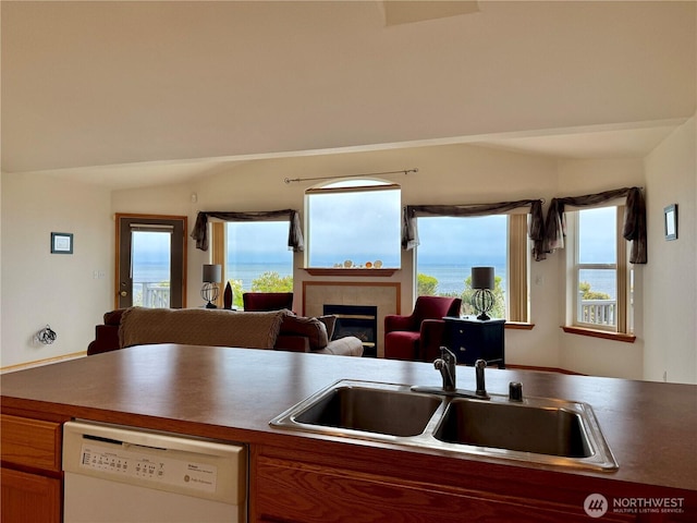 374 Harbor View Loop SE, Ocean Shores, WA 98569 - kitchen with dishwasher, a sink, a fireplace, open floor plan, and lofted ceiling