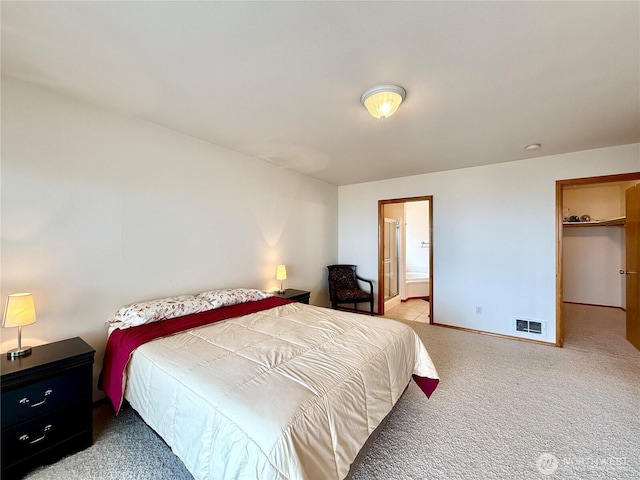 374 Harbor View Loop SE, Ocean Shores, WA 98569 - bedroom featuring carpet floors, baseboards, a walk in closet, and connected bathroom